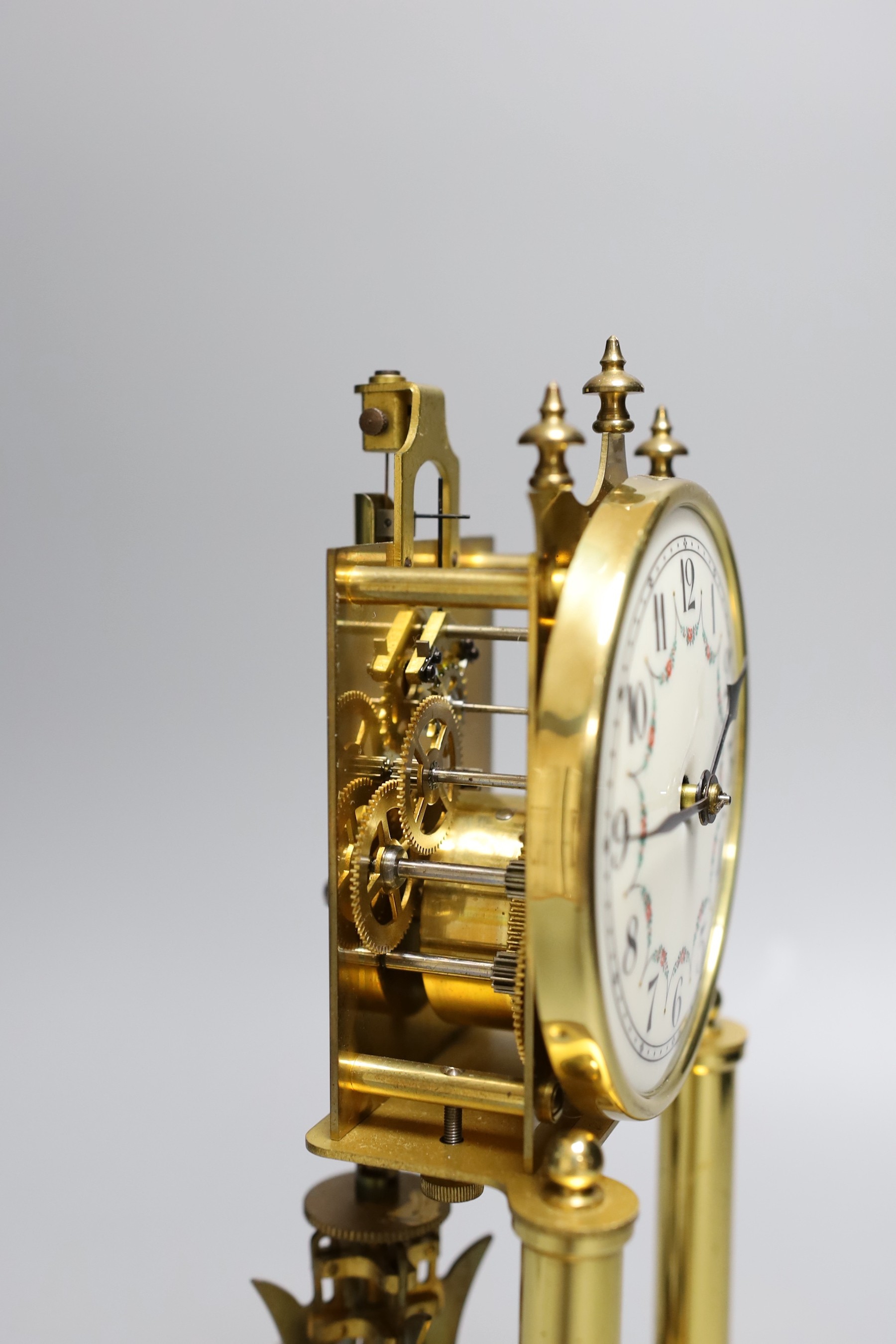 A German 400 day brass mantel timepiece, under a glass dome, 30cm total height